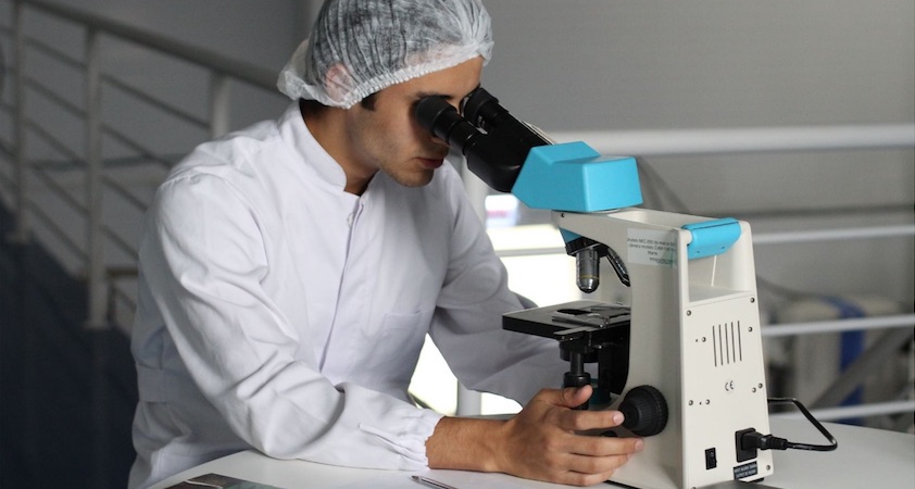 pharmacist using microscope