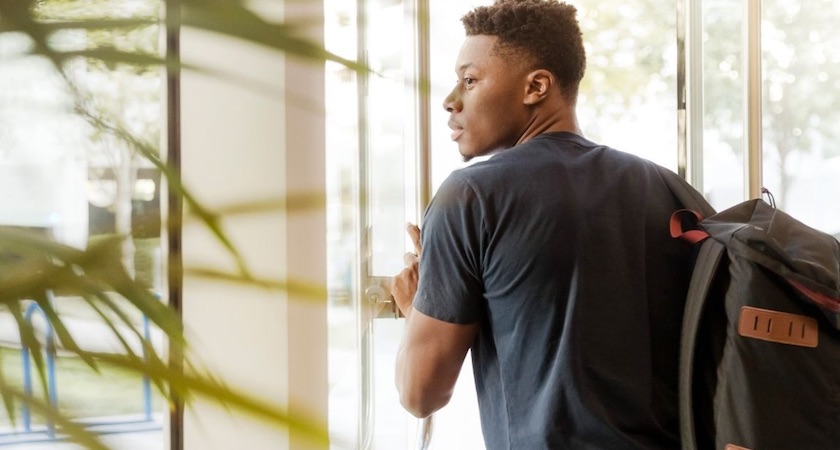 man walking through door